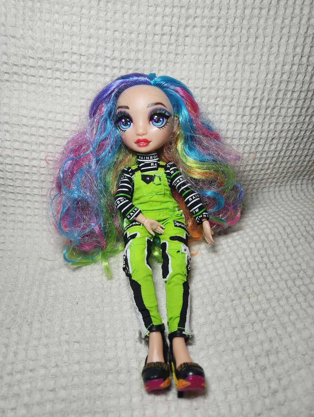 Rainbow High Amaya Raine fashion doll dressed in a neon green tracksuit